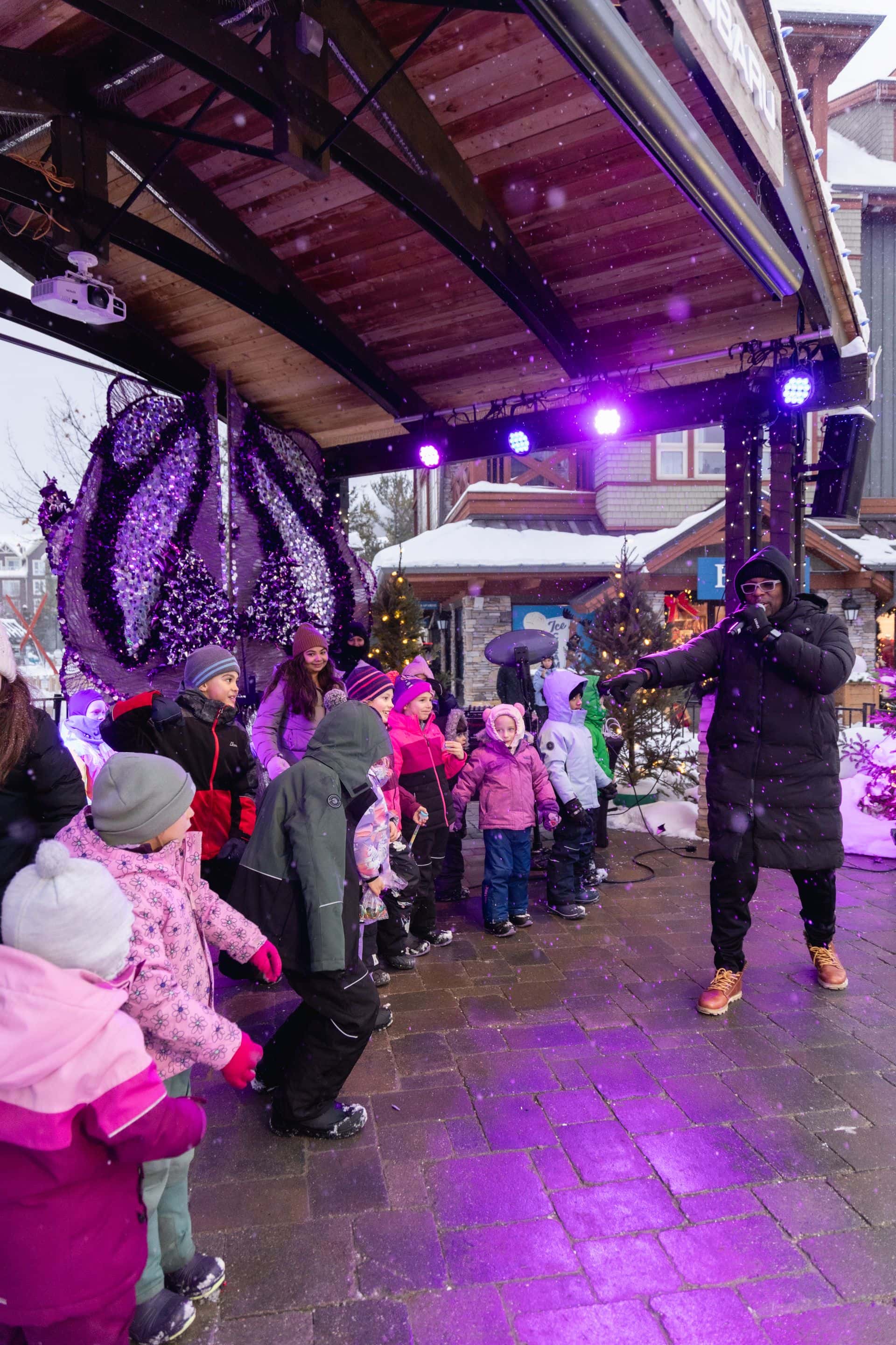 Group of kids join the Caribbean Winterfest host on stage for interactive performance.